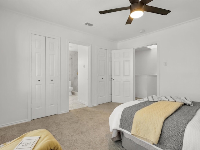 bedroom with light carpet, ornamental molding, ceiling fan, and ensuite bathroom