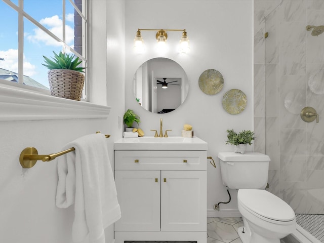 bathroom with vanity, toilet, and a tile shower