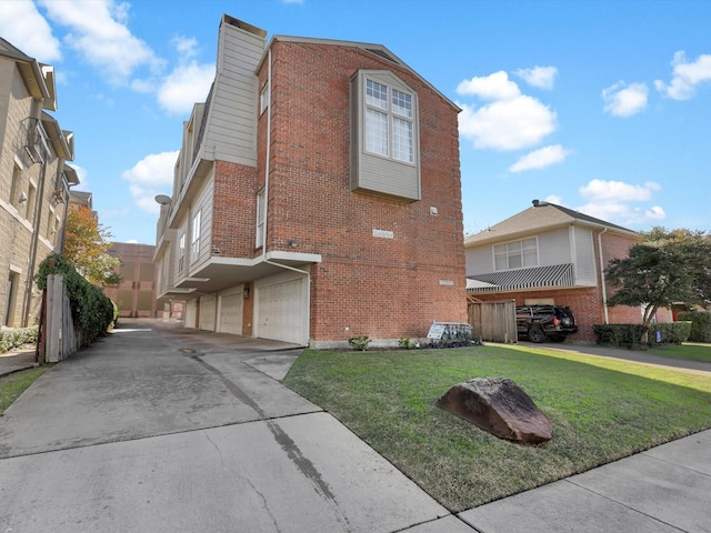 view of side of property with a garage and a lawn