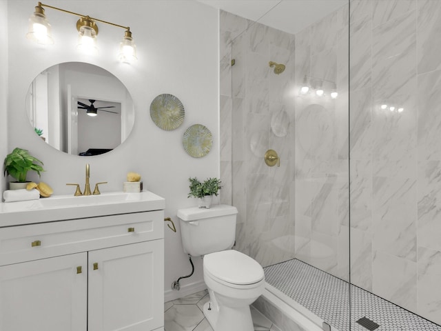 bathroom featuring vanity, a tile shower, and toilet