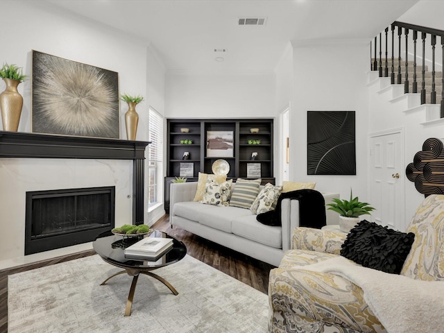 living room with dark wood-type flooring and a premium fireplace