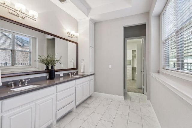 bathroom with plenty of natural light and vanity