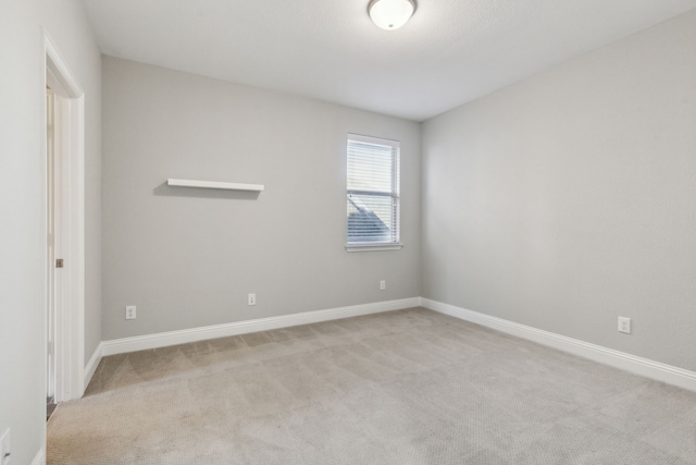 unfurnished room with light colored carpet