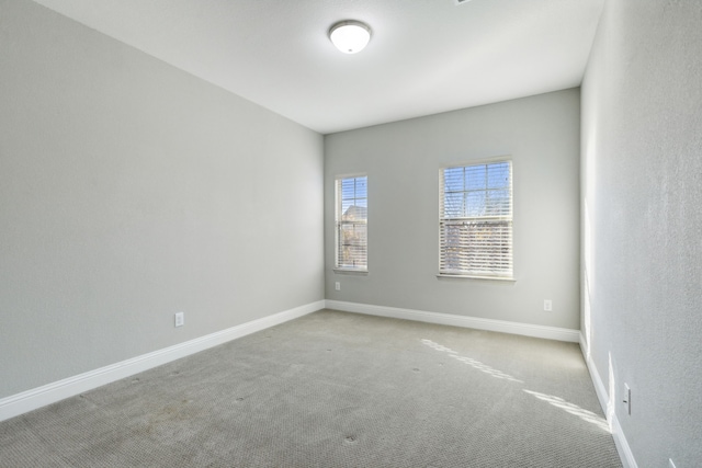 unfurnished room with light carpet