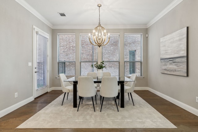 dining room with ornamental molding, dark wood-type flooring, and an inviting chandelier