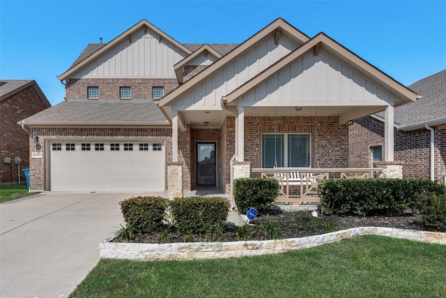 craftsman inspired home featuring covered porch, a garage, and a front lawn