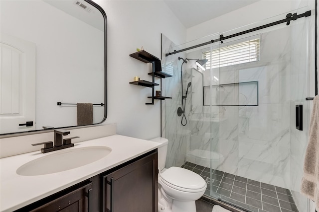 bathroom with vanity, toilet, and a shower with door