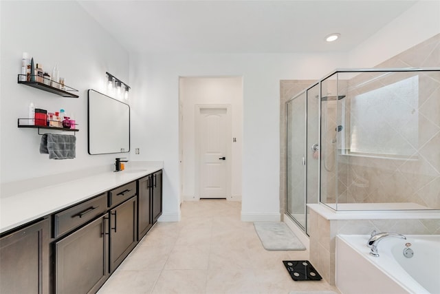 bathroom featuring tile patterned flooring, vanity, and separate shower and tub