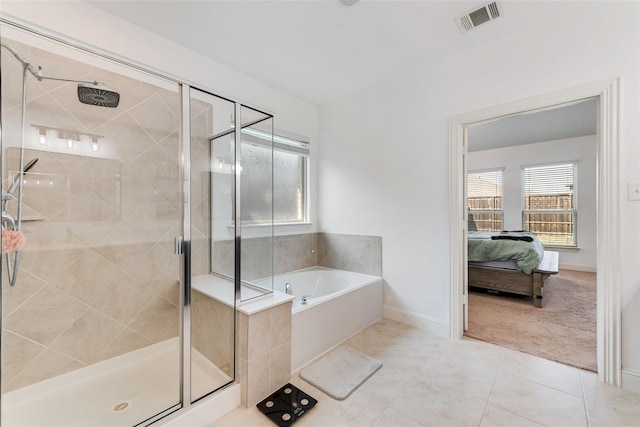 bathroom with shower with separate bathtub, tile patterned floors, and a healthy amount of sunlight