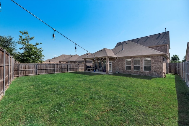 back of house with a patio and a lawn