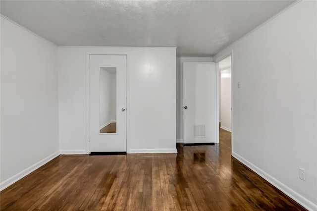 unfurnished bedroom with dark hardwood / wood-style floors