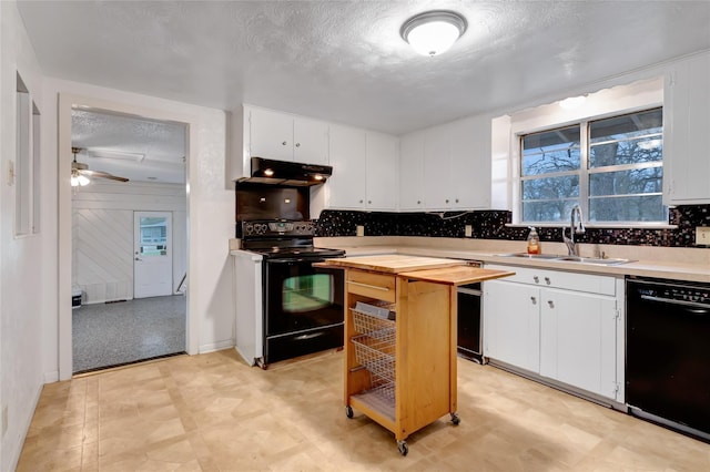 kitchen featuring tasteful backsplash, white cabinetry, sink, black appliances, and a textured ceiling