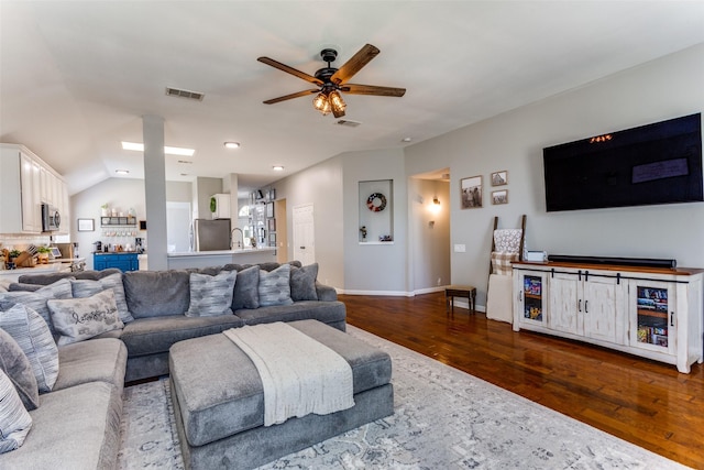 living room with lofted ceiling, ceiling fan, sink, and dark hardwood / wood-style floors