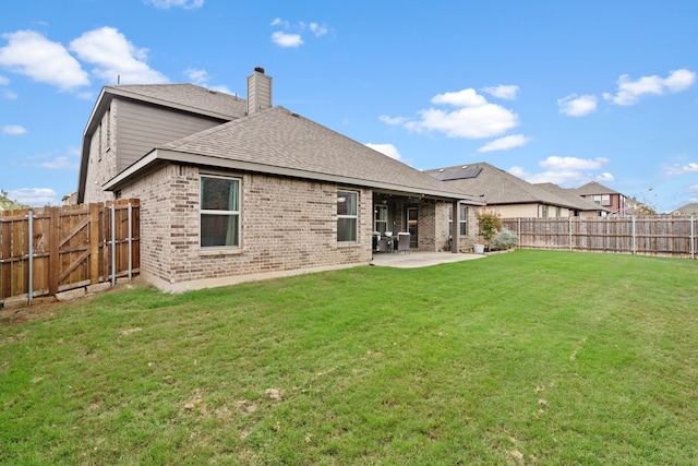 back of house featuring a yard and a patio area