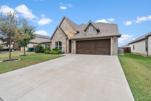 view of front facade featuring a garage, central AC, and a front yard