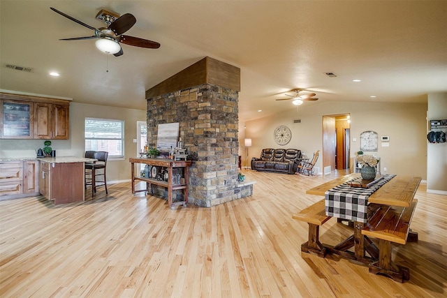 living room with vaulted ceiling, ceiling fan, and light hardwood / wood-style flooring