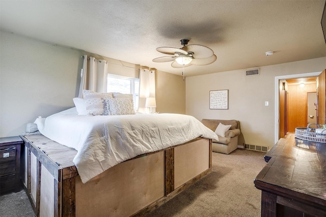 carpeted bedroom with ceiling fan and a textured ceiling