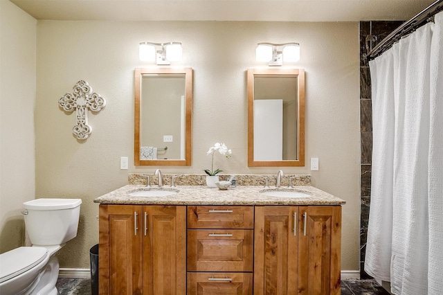 bathroom featuring toilet, vanity, and curtained shower