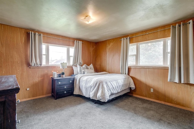 carpeted bedroom with wooden walls