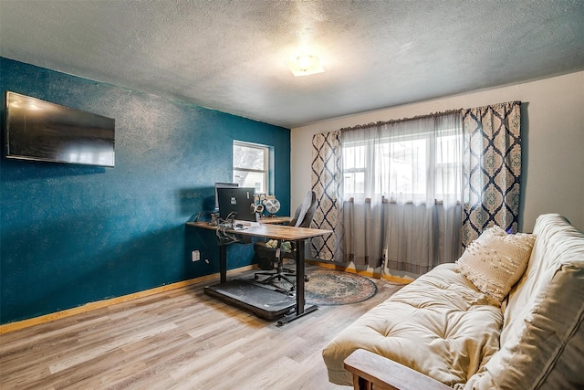 office with hardwood / wood-style flooring and a textured ceiling