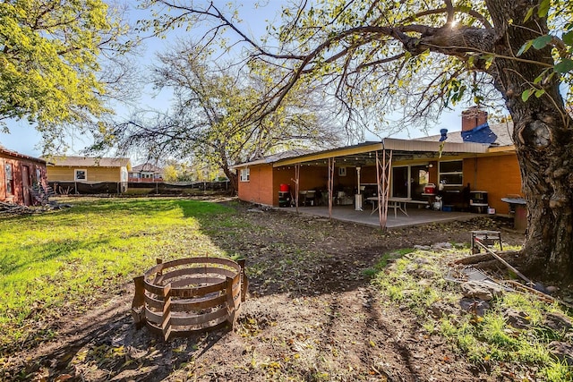 view of yard featuring an outdoor fire pit and a patio