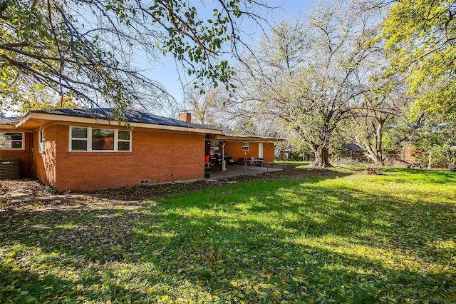 view of yard with central air condition unit and a patio area