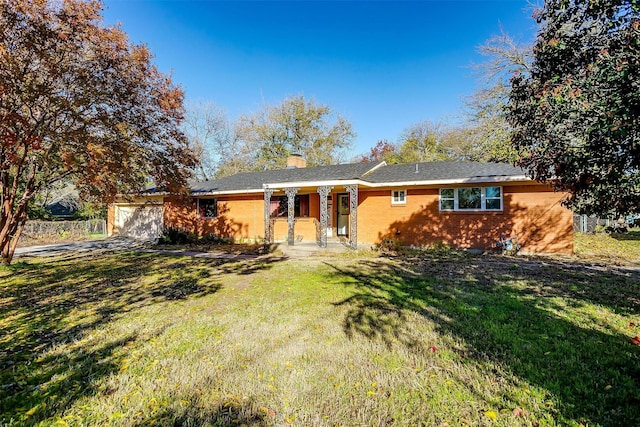 view of front of property with a garage and a front lawn