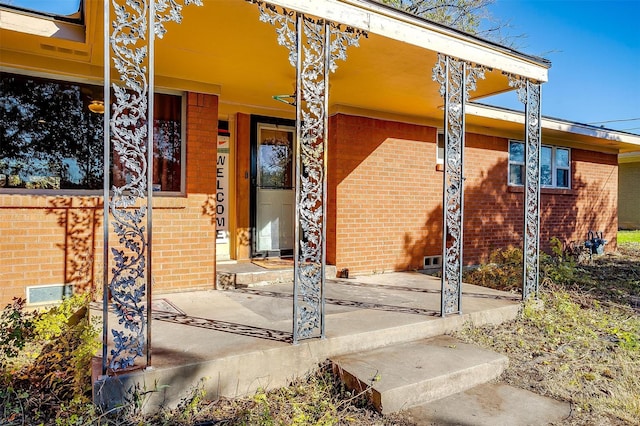 view of exterior entry with a porch