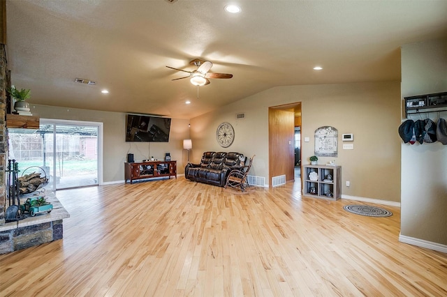 living area with light hardwood / wood-style floors, vaulted ceiling, and ceiling fan