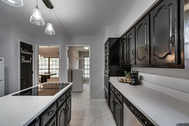 305 Santa Fe Trl, Waxahachie, TX 75165 - kitchen featuring stainless steel appliances, light marble finish floors, dark cabinets, hanging light fixtures, and light stone countertops