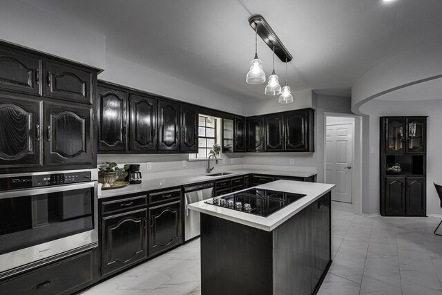 305 Santa Fe Trl, Waxahachie, TX 75165 - kitchen featuring appliances with stainless steel finishes, light marble finish floors, light countertops, dark cabinetry, and a center island