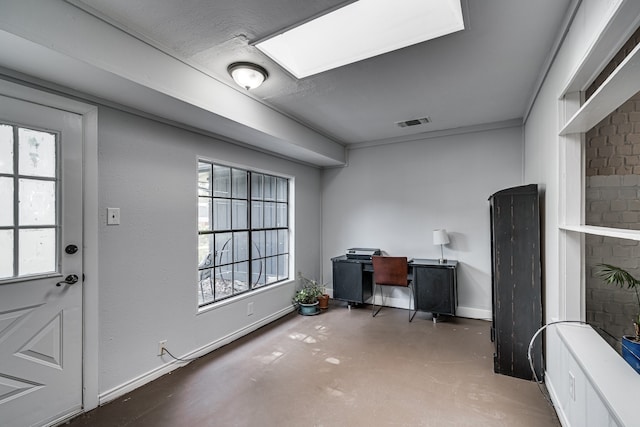 office area featuring a skylight and a fireplace