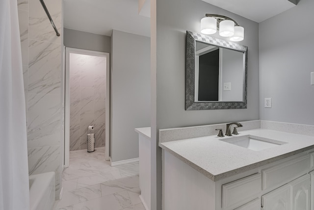 bathroom featuring vanity and tiled shower / bath