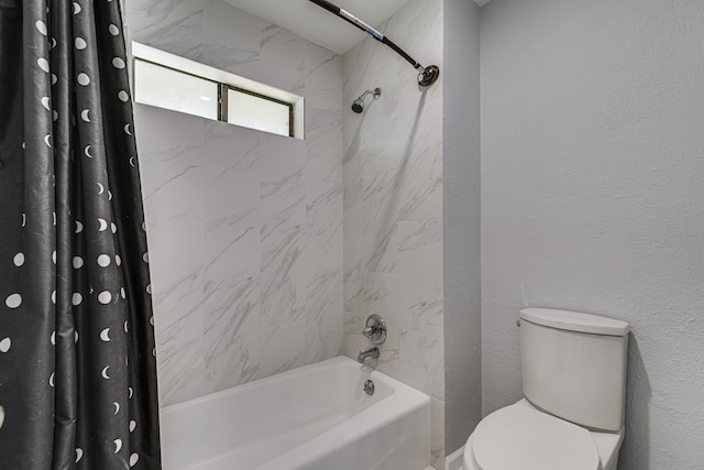 bathroom featuring shower / tub combo with curtain and toilet