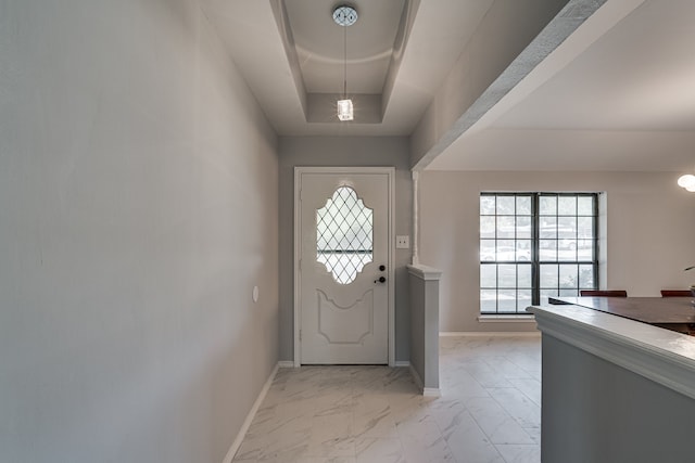 doorway featuring a tray ceiling