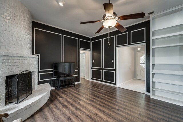 305 Santa Fe Trl, Waxahachie, TX 75165 - unfurnished living room with a decorative wall, built in features, ceiling fan, crown molding, and wood finished floors