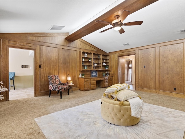 living area with light colored carpet, wood walls, built in desk, and lofted ceiling with beams