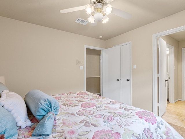 bedroom featuring ceiling fan and a closet