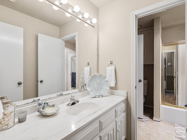 bathroom with toilet, tile patterned flooring, and vanity