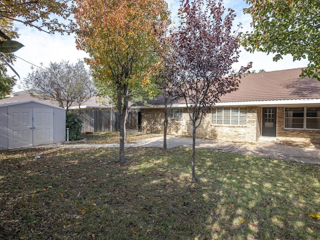 view of yard with a shed and a patio area