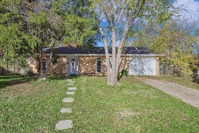 ranch-style home with a garage and a front yard