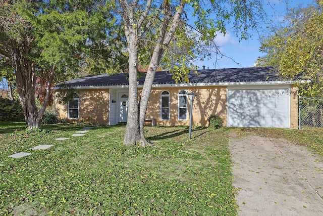 ranch-style house with a garage and a front yard