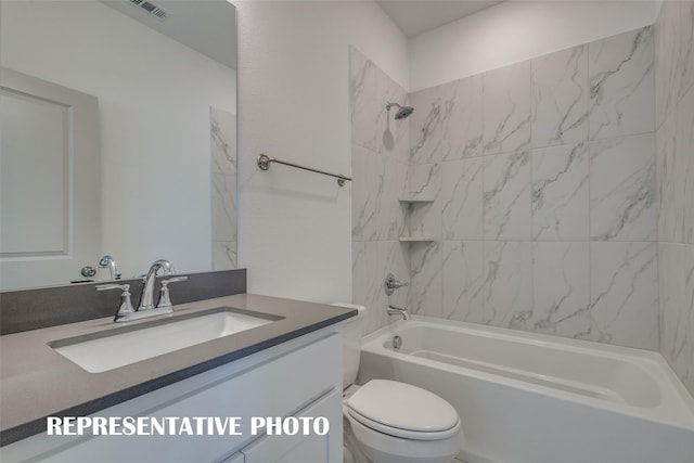 full bathroom featuring toilet, vanity, and tiled shower / bath