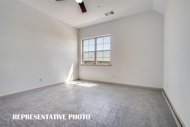 carpeted spare room featuring ceiling fan and vaulted ceiling