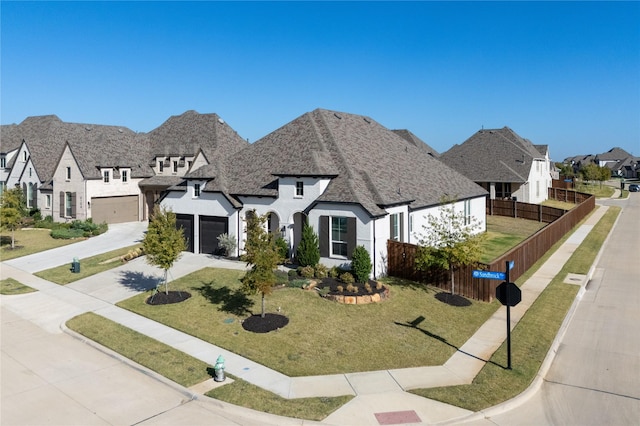 view of front of property with a front yard and a garage