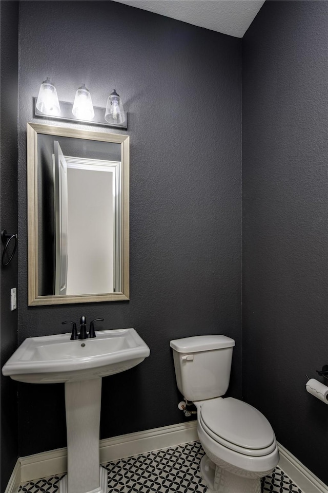 4100 Sandbrock Pkwy, Aubrey, TX 76227 - half bathroom with toilet, a sink, and baseboards