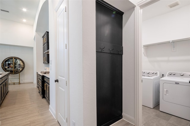 washroom featuring separate washer and dryer and light wood-type flooring