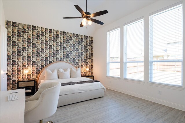 bedroom with light wood-type flooring, multiple windows, and ceiling fan