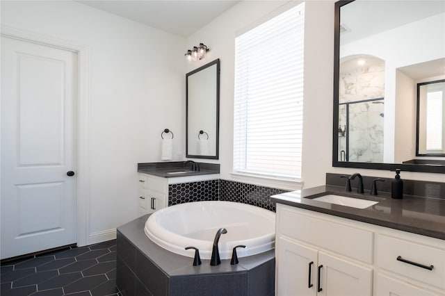 bathroom featuring tile patterned flooring, vanity, and shower with separate bathtub