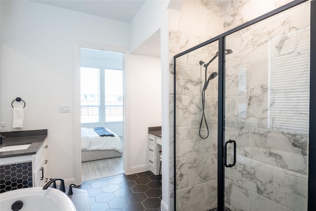 bathroom featuring tile patterned flooring, vanity, and a shower with door